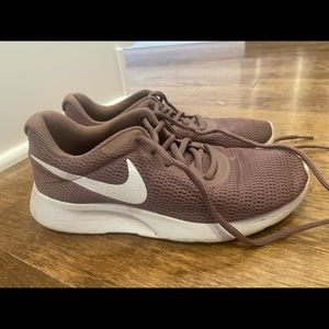 Women’s Nike athletic shoe, mauve and white colors, good condition in size 7.5